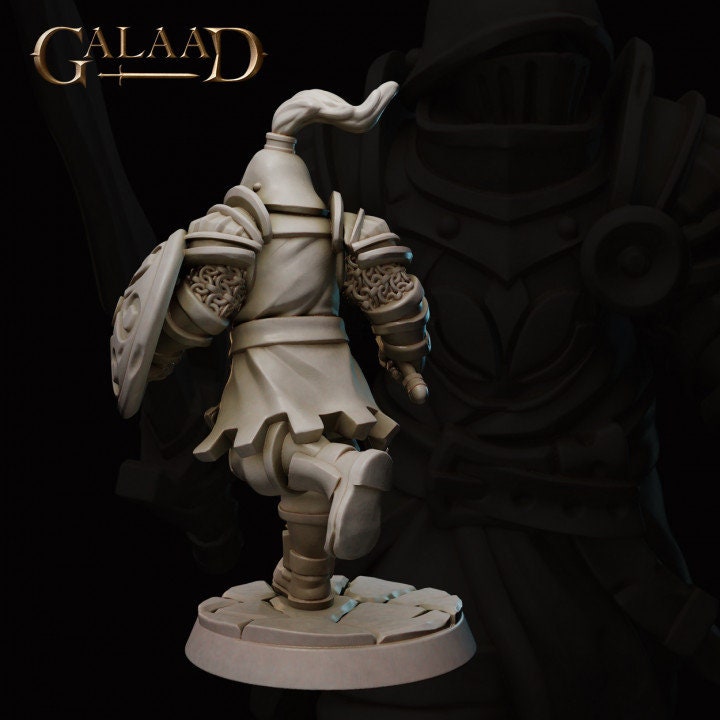 a close up of a statue of a person holding a sword