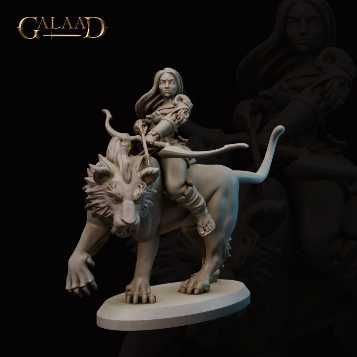 a statue of a woman riding a lion